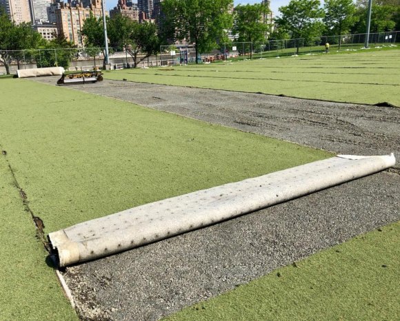 Major Work Begins To Restore Octagon Field Worn out artificial surface rolled back, exposing undersurface for the first time in ten years.